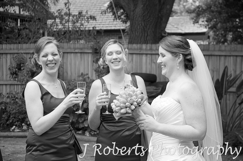 Bride laughing with bridesmaids and champagne - wedding photography sydney